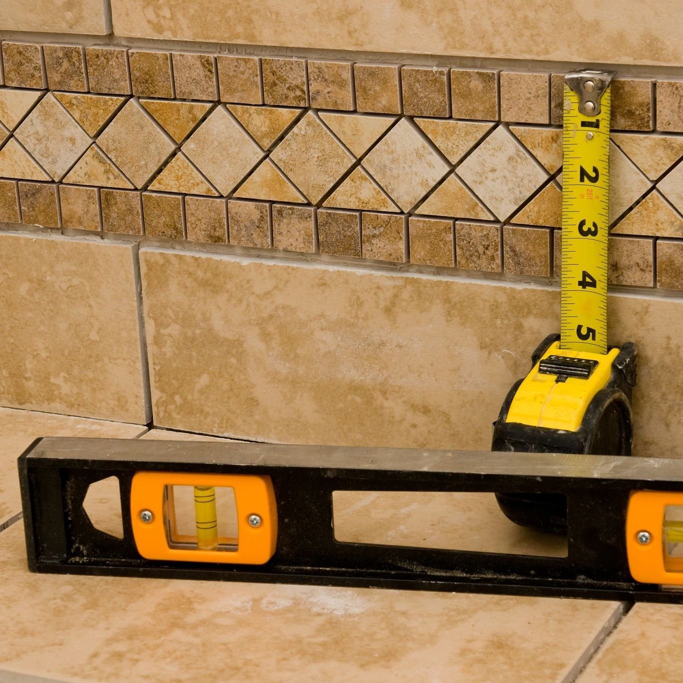 measure tape and level against tile - Home Design of Hastings in Hastings, MN