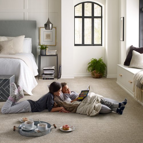 two kids reading on carpet in bedroom - Home Design of Hastings in Hastings, MN